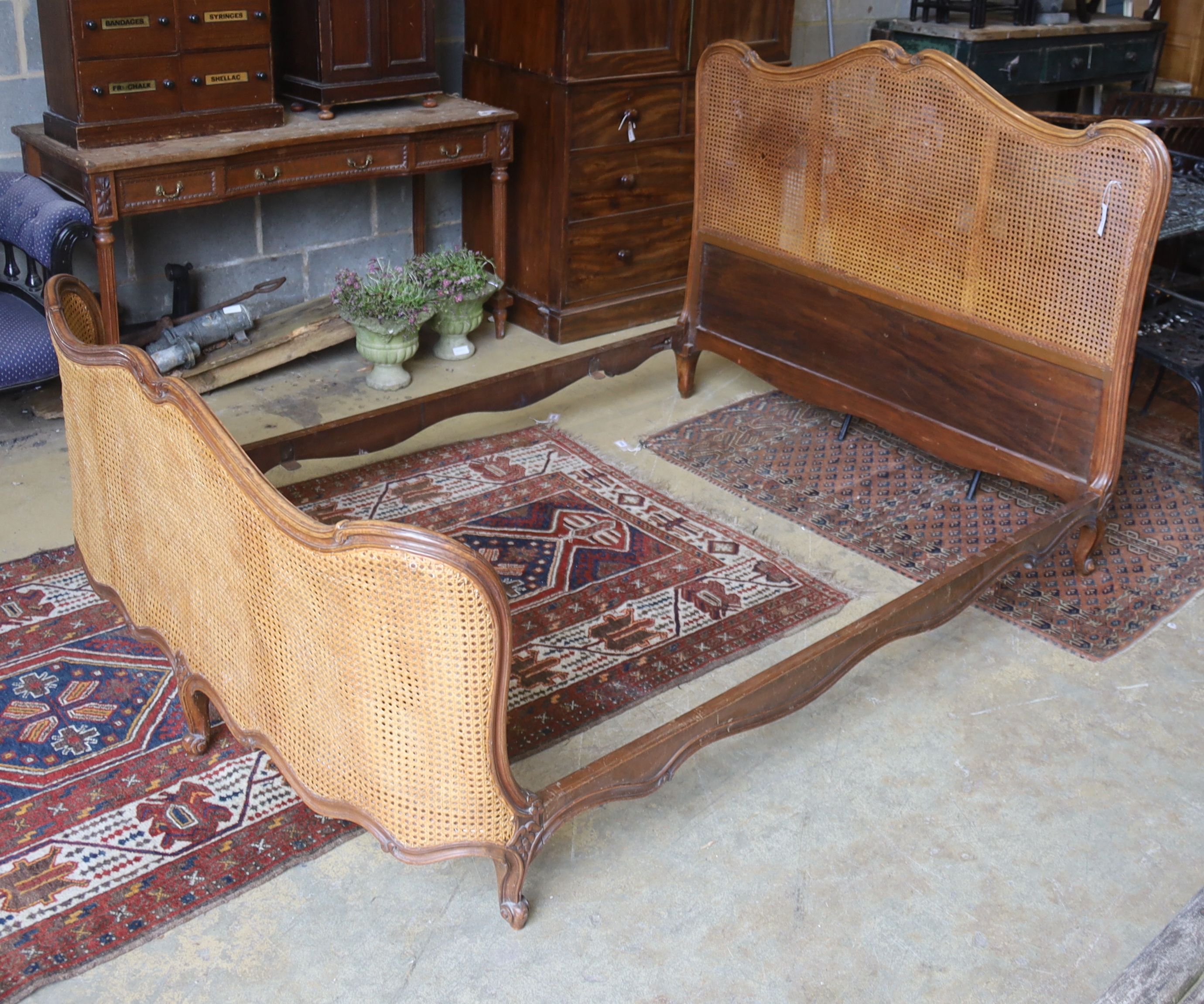 A late 19th / early 20th century French caned walnut double bedframe, width 150cm, length 210cm